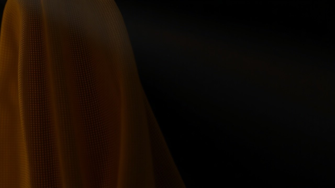 a close section of aged linen weave draped over a dark surface, faint straw-yellow discoloration fading across the fibers, lit by a single narrow beam from above